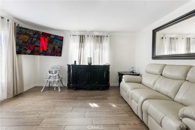 a living room with furniture a air conditioner vent and a window
