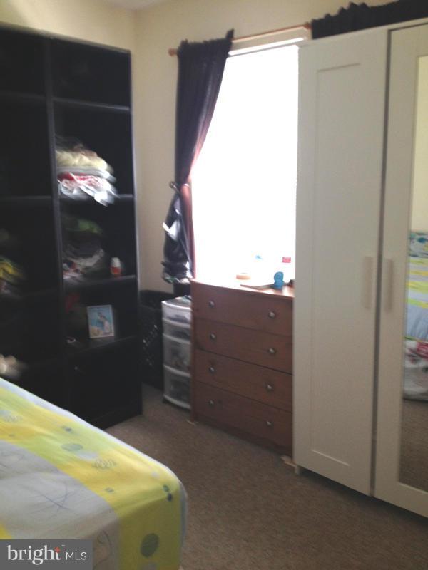 1720 Wilcox Lane Silver Spring, MD 20906 - Photo 14 of 27 a bedroom with a bed and a mirror
