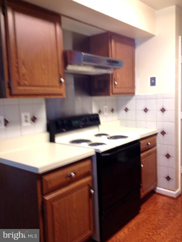1720 Wilcox Lane Silver Spring, MD 20906 - Photo 8 of 27 a kitchen with stainless steel appliances a sink dishwasher and cabinets