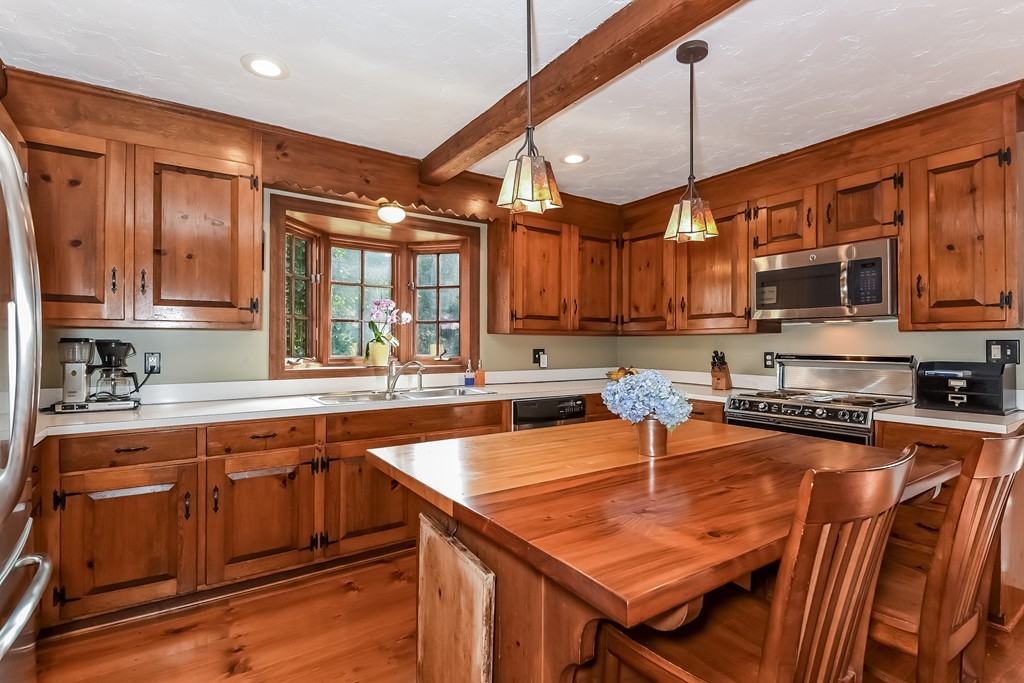 243 Newbury Road Rowley, MA 01969 - Photo 4 of 23 a kitchen with stainless steel appliances granite countertop a sink a stove and cabinets