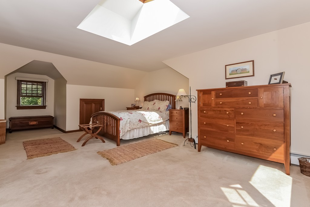 243 Newbury Road Rowley, MA 01969 - Photo 10 of 23 a room with a bed and a tv