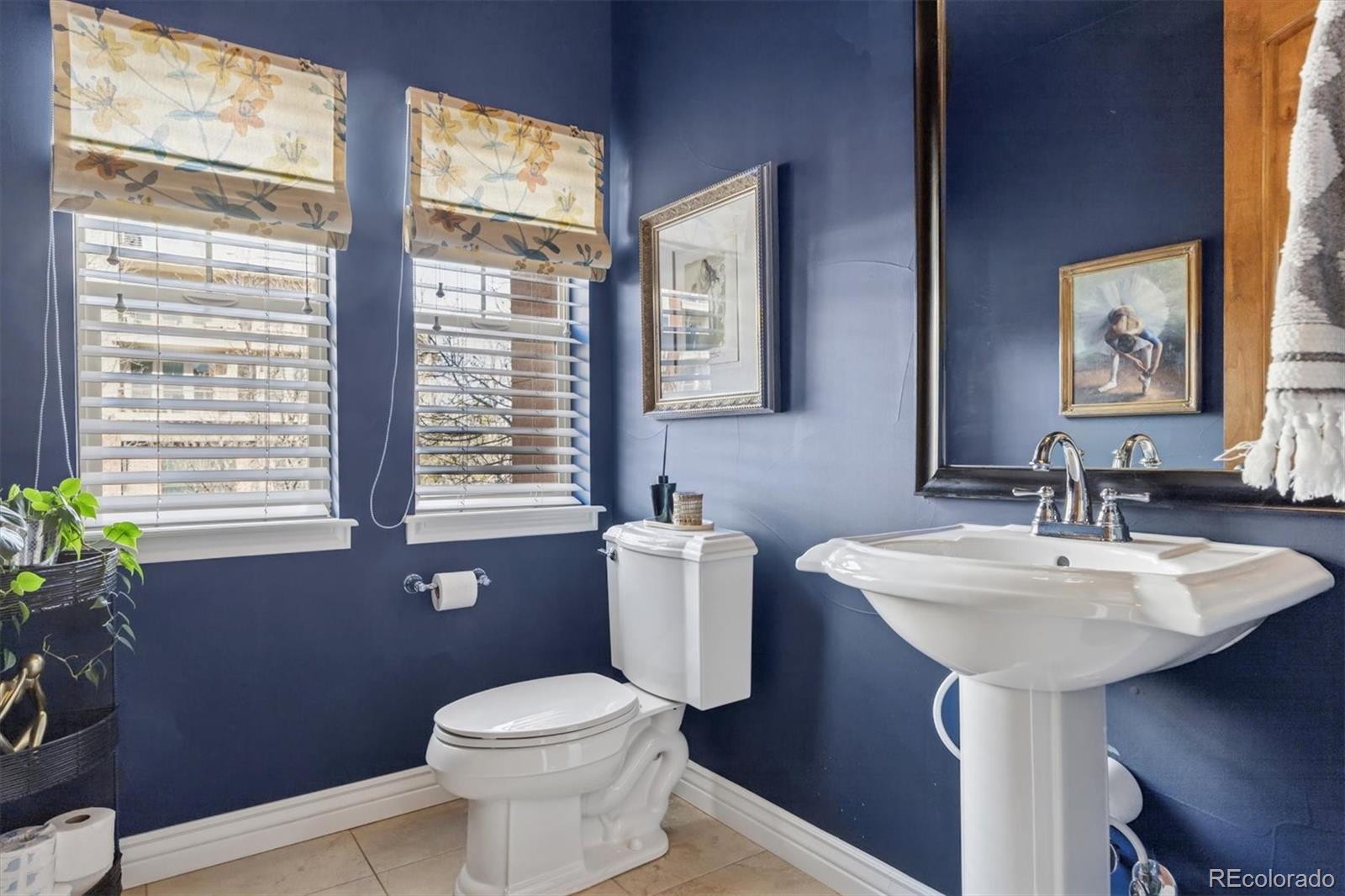 10130 Inverness Main Street Englewood, CO 80112 - Photo 15 of 44 a bathroom with a toilet sink and mirror