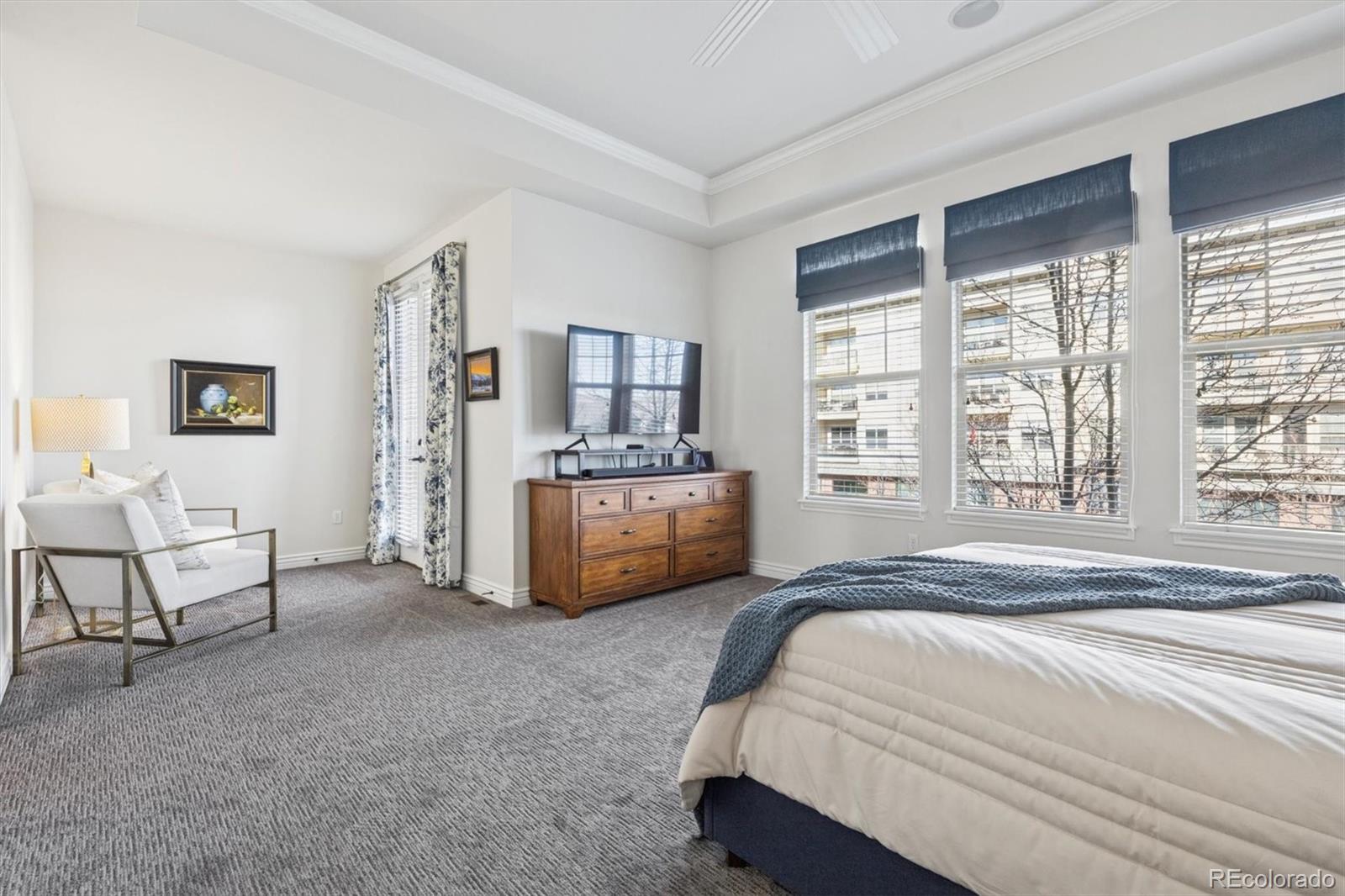 10130 Inverness Main Street Englewood, CO 80112 - Photo 19 of 44 a spacious bedroom with a bed and a large window