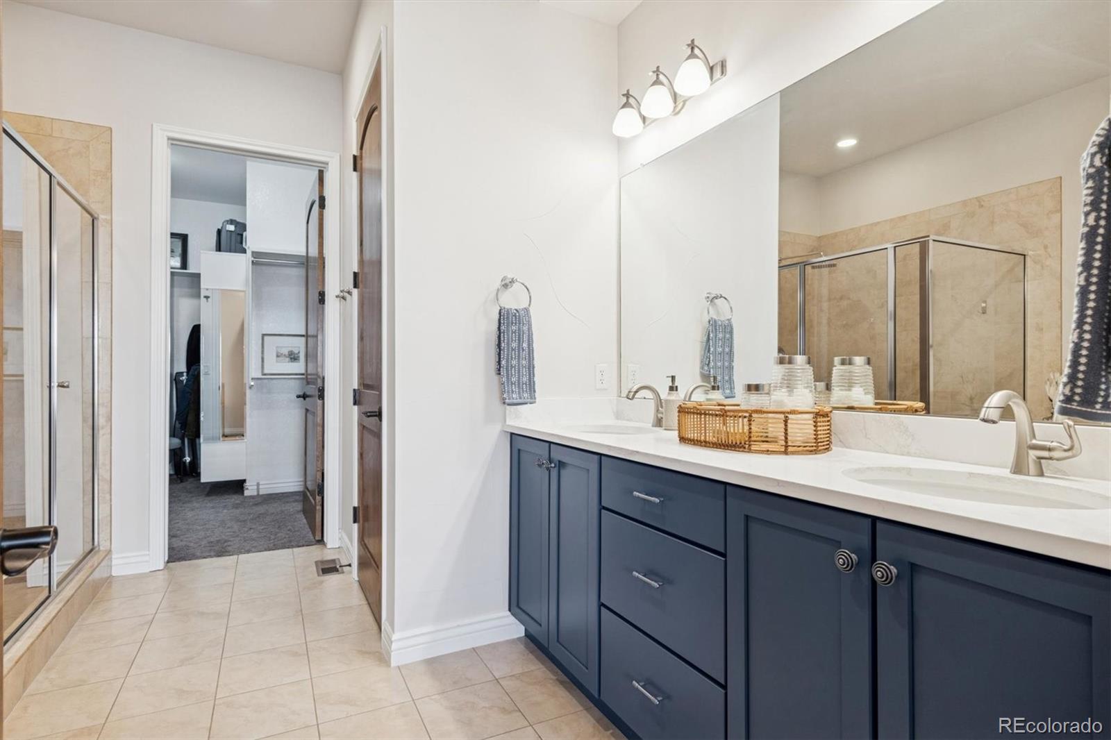 10130 Inverness Main Street Englewood, CO 80112 - Photo 22 of 44 a spacious bathroom with a double vanity sink mirror and double