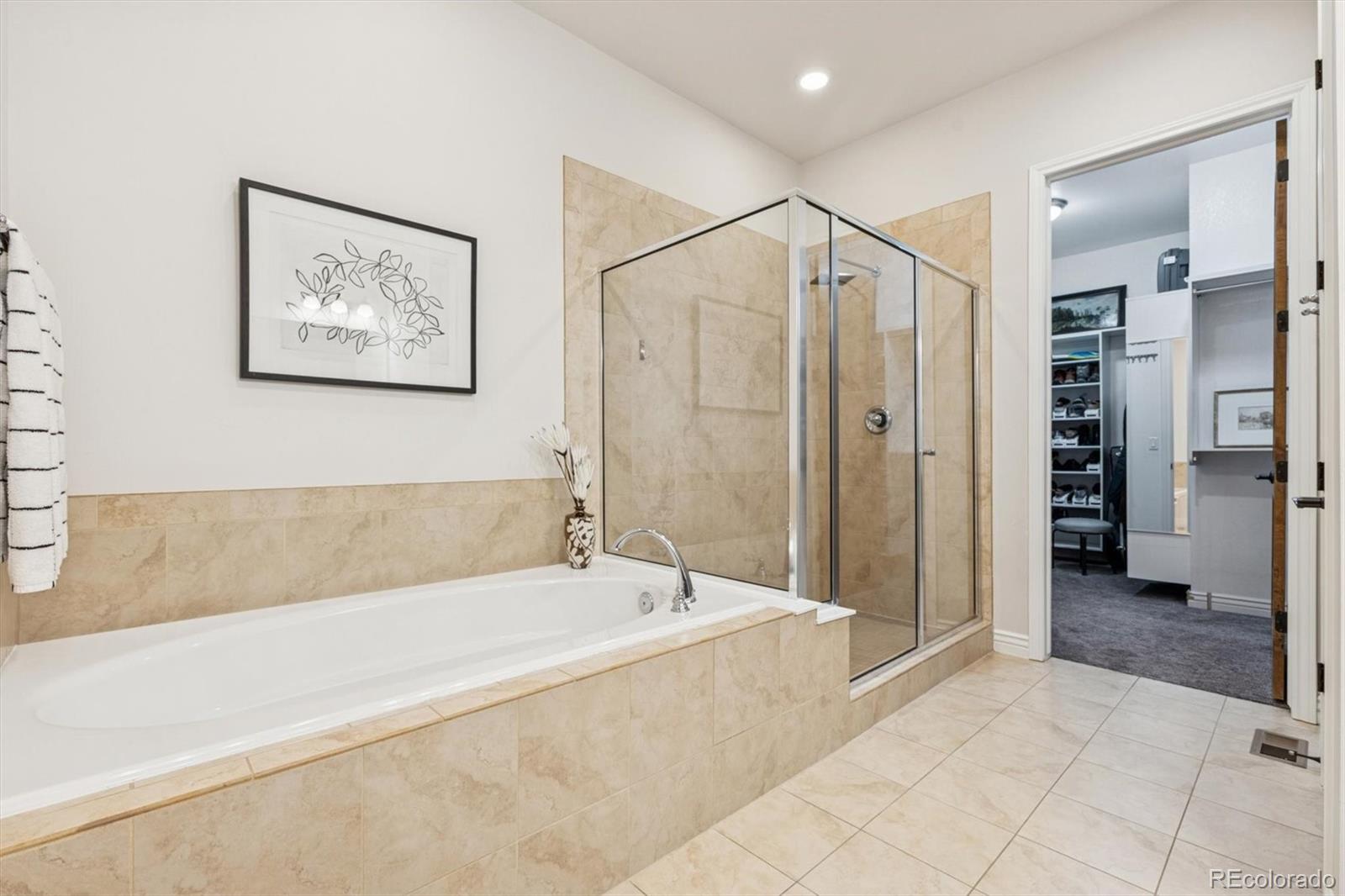 10130 Inverness Main Street Englewood, CO 80112 - Photo 23 of 44 a spacious bathroom with a bathtub and a shower
