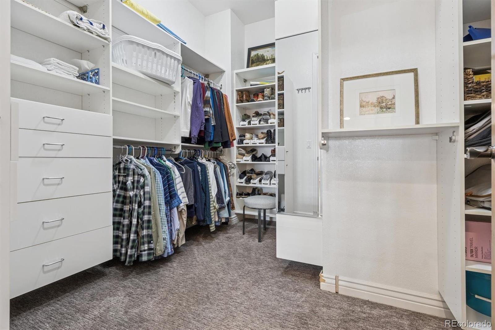 10130 Inverness Main Street Englewood, CO 80112 - Photo 25 of 44 a view of walk in closet with clothes and shoes