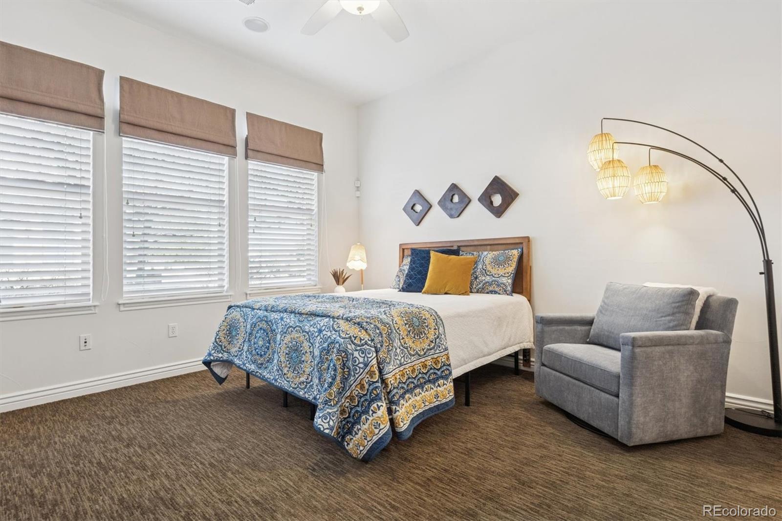 10130 Inverness Main Street Englewood, CO 80112 - Photo 29 of 44 a bedroom with a bed couch and window