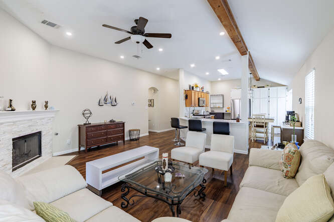 213 Chandler Crossing Trail Round Rock, TX 78665 - Photo 11 of 34 Living area with dark wood finished floors, a stone fireplace, ceiling fan, and recessed lighting