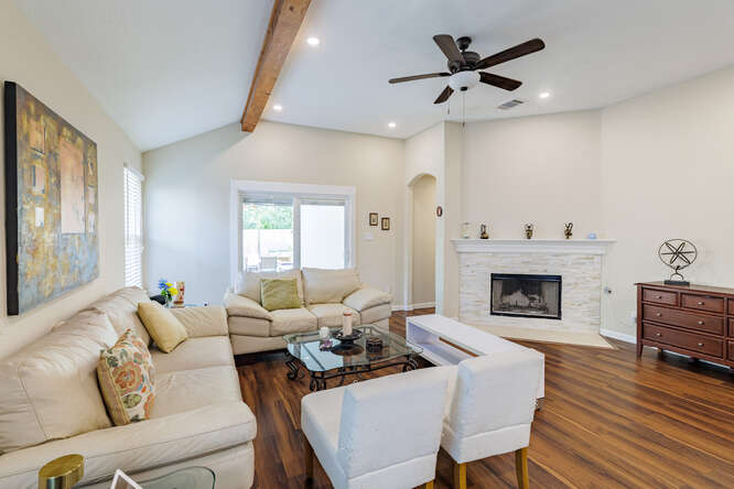 213 Chandler Crossing Trail Round Rock, TX 78665 - Photo 12 of 34 Living area with dark wood finished floors, a fireplace with flush hearth, recessed lighting, arched walkways, and a ceiling fan
