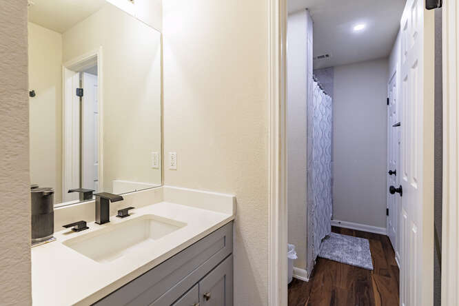 213 Chandler Crossing Trail Round Rock, TX 78665 - Photo 13 of 34 Full bath with vanity, dark wood-style flooring, and a shower with shower curtain