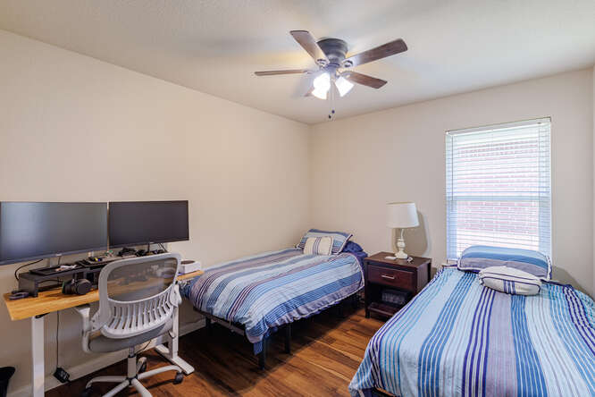 213 Chandler Crossing Trail Round Rock, TX 78665 - Photo 14 of 34 Bedroom with dark wood finished floors, an office area, and a ceiling fan
