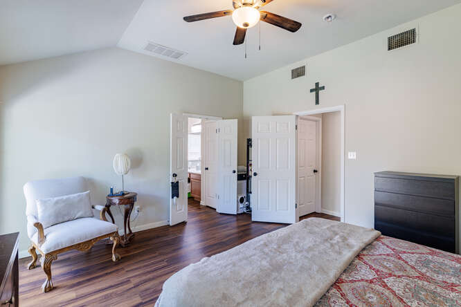 213 Chandler Crossing Trail Round Rock, TX 78665 - Photo 18 of 34 Bedroom featuring dark wood-style floors, lofted ceiling, and ceiling fan