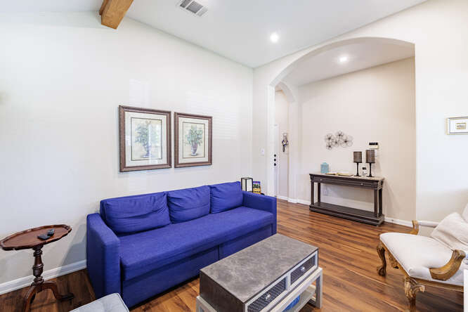 213 Chandler Crossing Trail Round Rock, TX 78665 - Photo 5 of 34 Living room with dark wood-style floors, arched walkways, recessed lighting, and beam ceiling