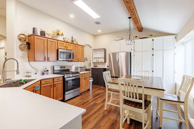 213 Chandler Crossing Trail Round Rock, TX 78665 - Photo 6 of 34 Kitchen featuring light countertops, stainless steel appliances, brown cabinetry, and recessed lighting