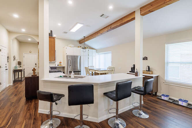 213 Chandler Crossing Trail Round Rock, TX 78665 - Photo 8 of 34 Kitchen featuring a breakfast bar area, dark wood-type flooring, light countertops, and recessed lighting