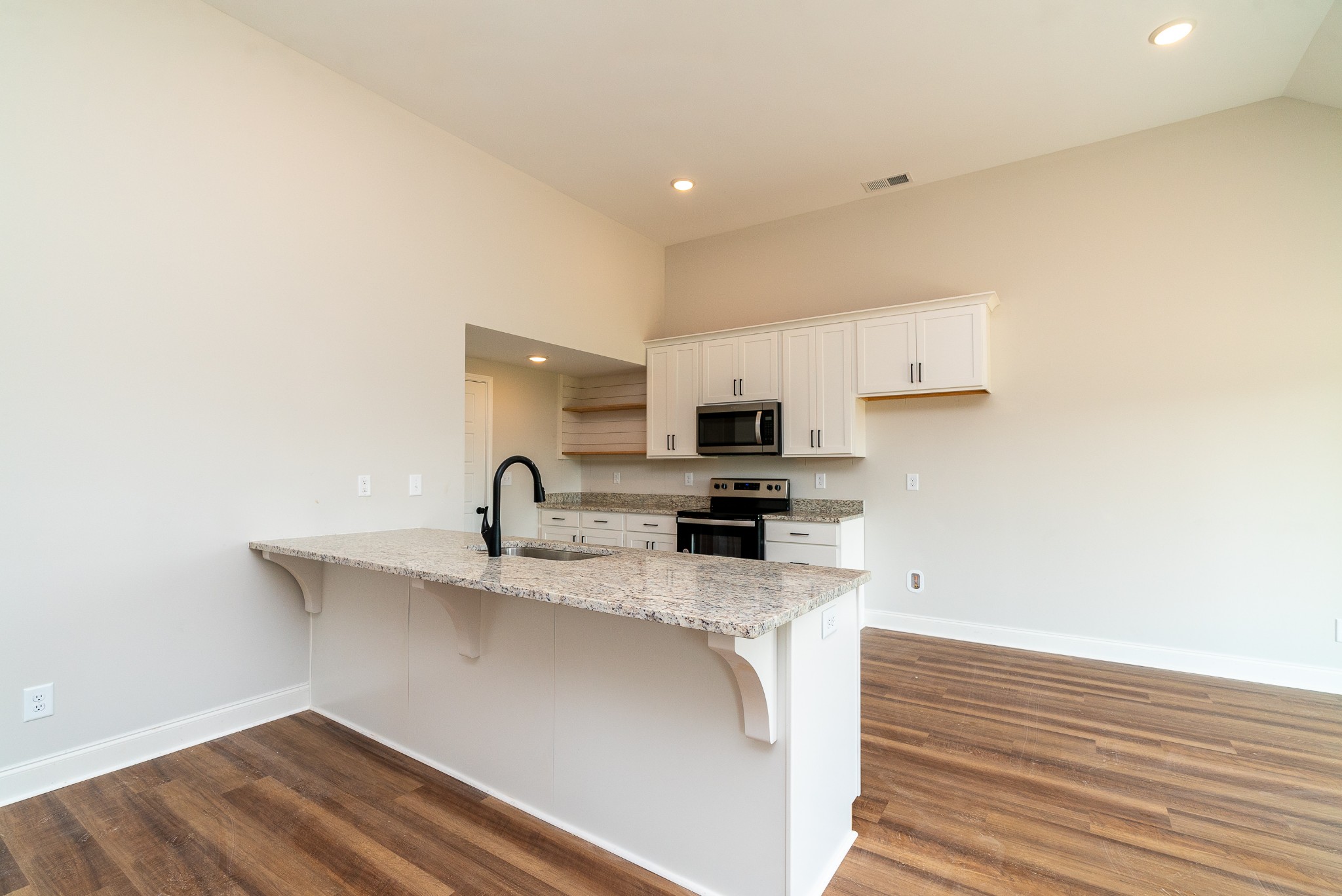 4144 Dot Road Springfield, TN 37172 - Photo 24 of 52 a kitchen with stainless steel appliances a sink a stove and a refrigerator with wooden floor