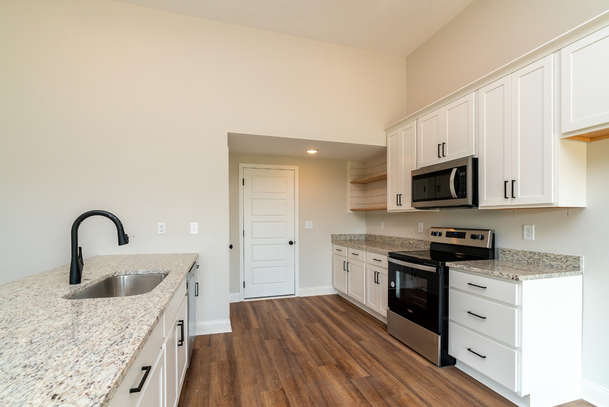 4144 Dot Road Springfield, TN 37172 - Photo 25 of 52 a kitchen with stainless steel appliances granite countertop a sink dishwasher a stove and a microwave oven with wooden floor