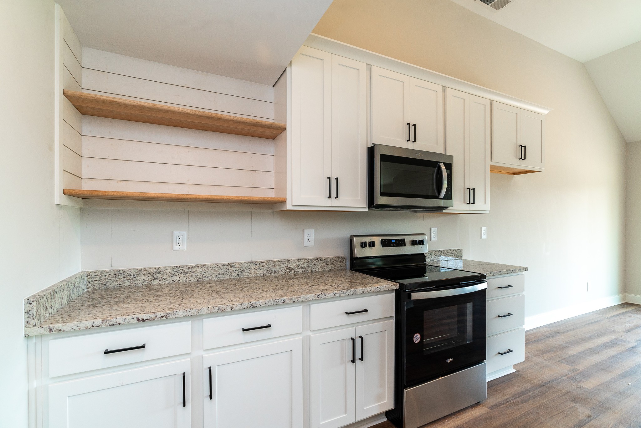 4144 Dot Road Springfield, TN 37172 - Photo 29 of 52 a kitchen with granite countertop white cabinets stainless steel appliances and wooden floor