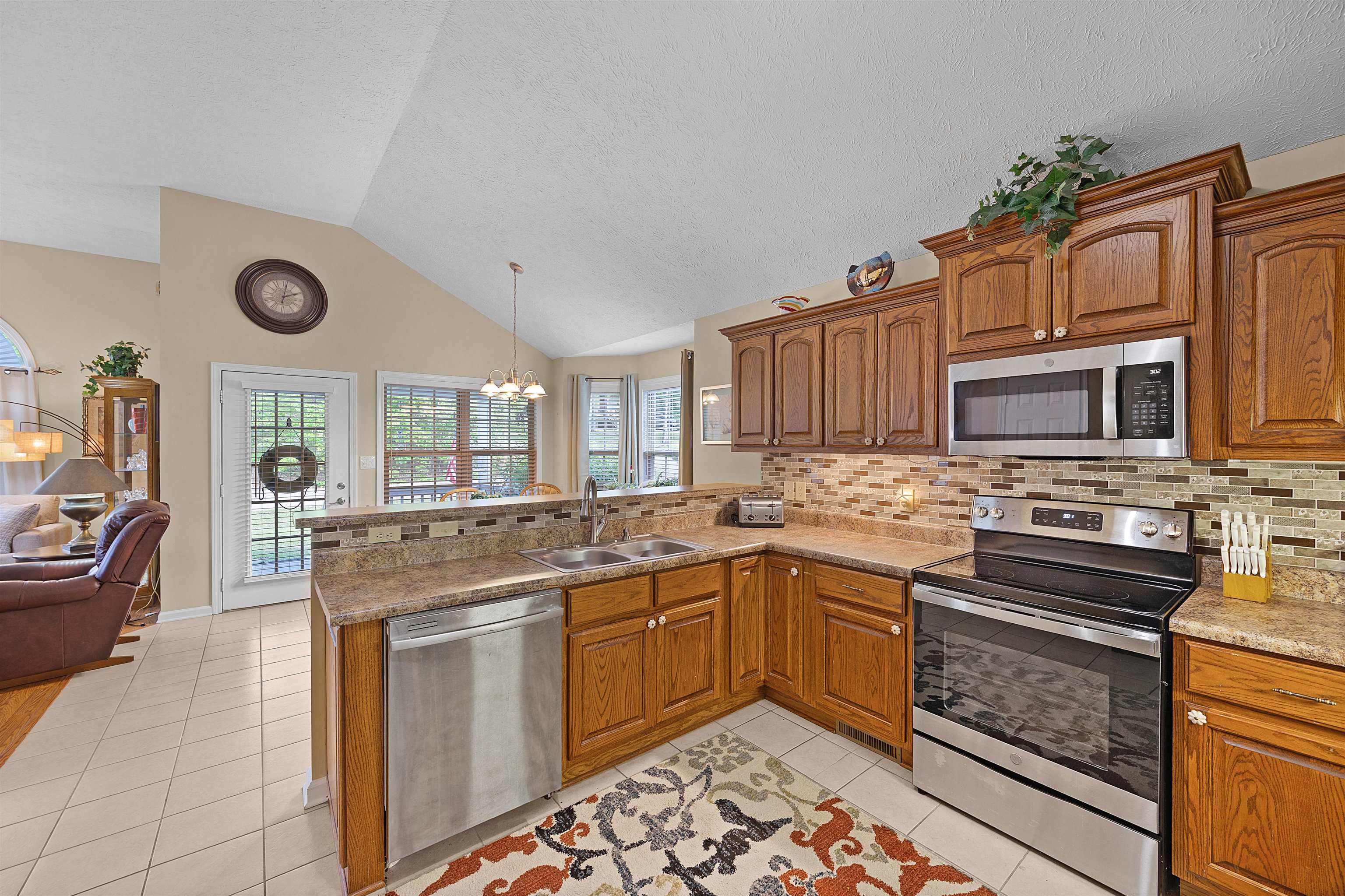 165 Ping Hl Cove Counce, TN 38326 - Photo 19 of 19 Kitchen featuring appliances with stainless steel finishes, a notable chandelier, a sink, a peninsula, and open floor plan