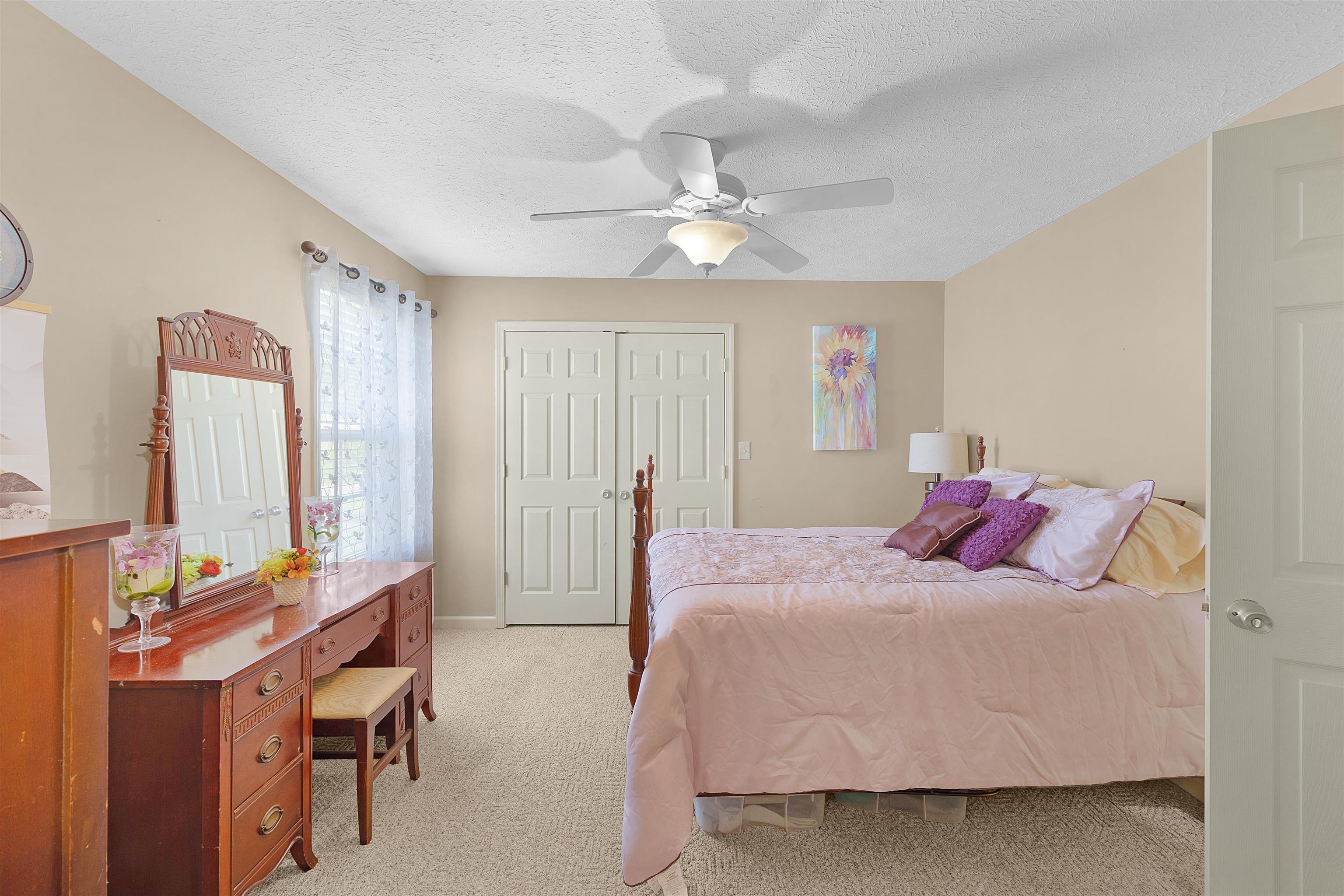 165 Ping Hl Cove Counce, TN 38326 - Photo 12 of 19 Bedroom featuring baseboards, ceiling fan, and light carpet