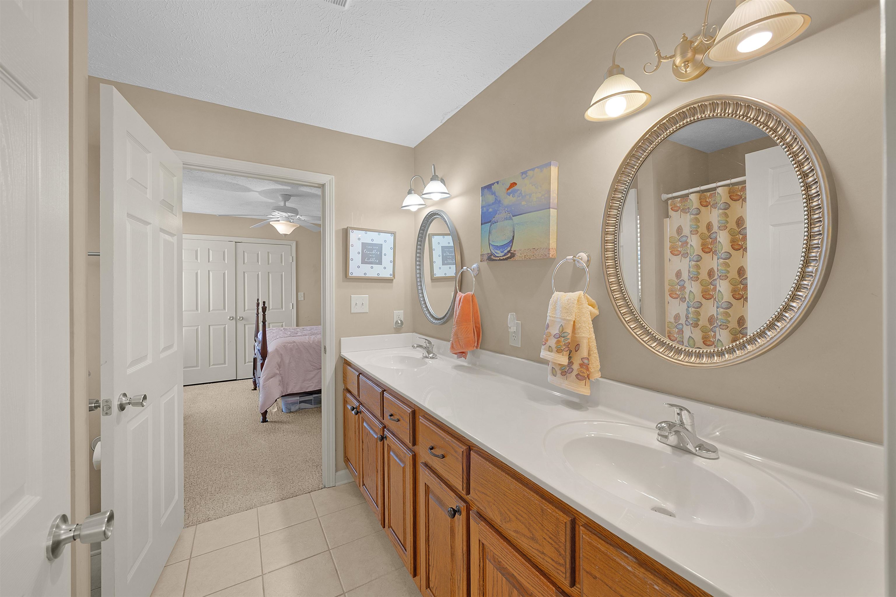 165 Ping Hl Cove Counce, TN 38326 - Photo 14 of 19 Full bathroom featuring a sink, tile patterned flooring, a ceiling fan, and double vanity
