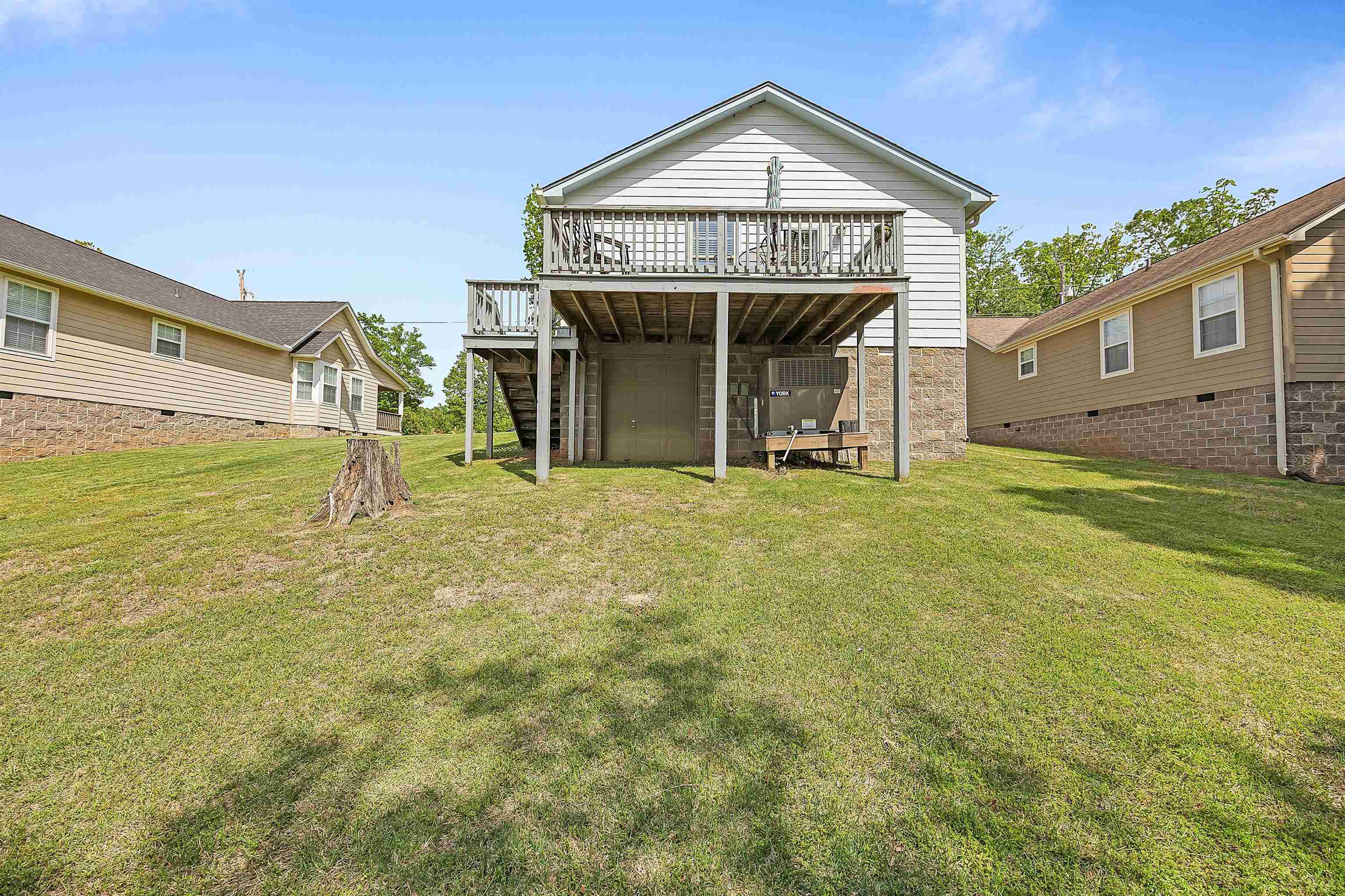 165 Ping Hl Cove Counce, TN 38326 - Photo 3 of 19 Rear view of house with a wooden deck, a yard, stairway, and crawl space