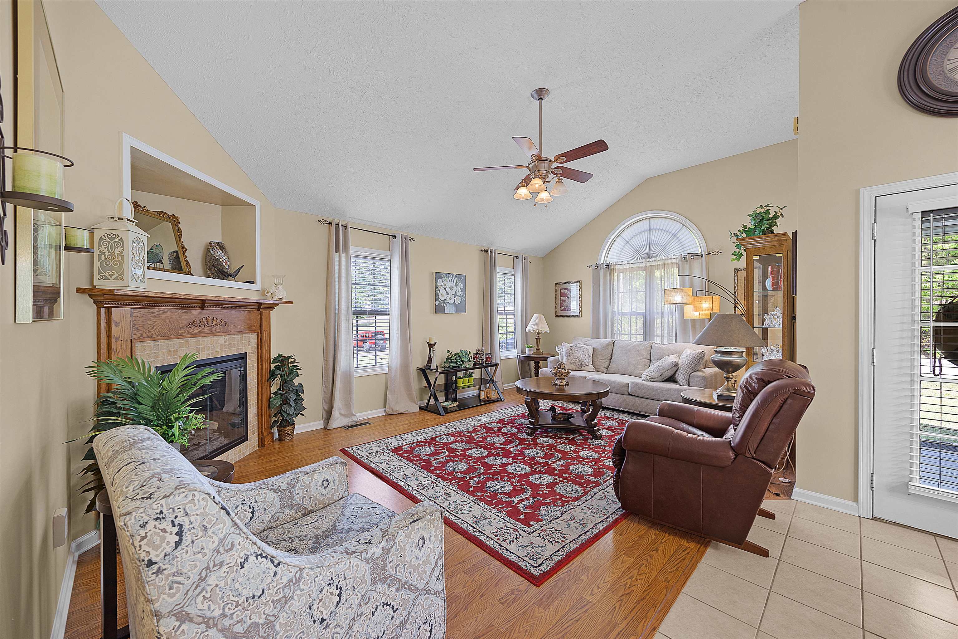 165 Ping Hl Cove Counce, TN 38326 - Photo 4 of 19 Living area featuring plenty of natural light, ceiling fan, a fireplace, and vaulted ceiling