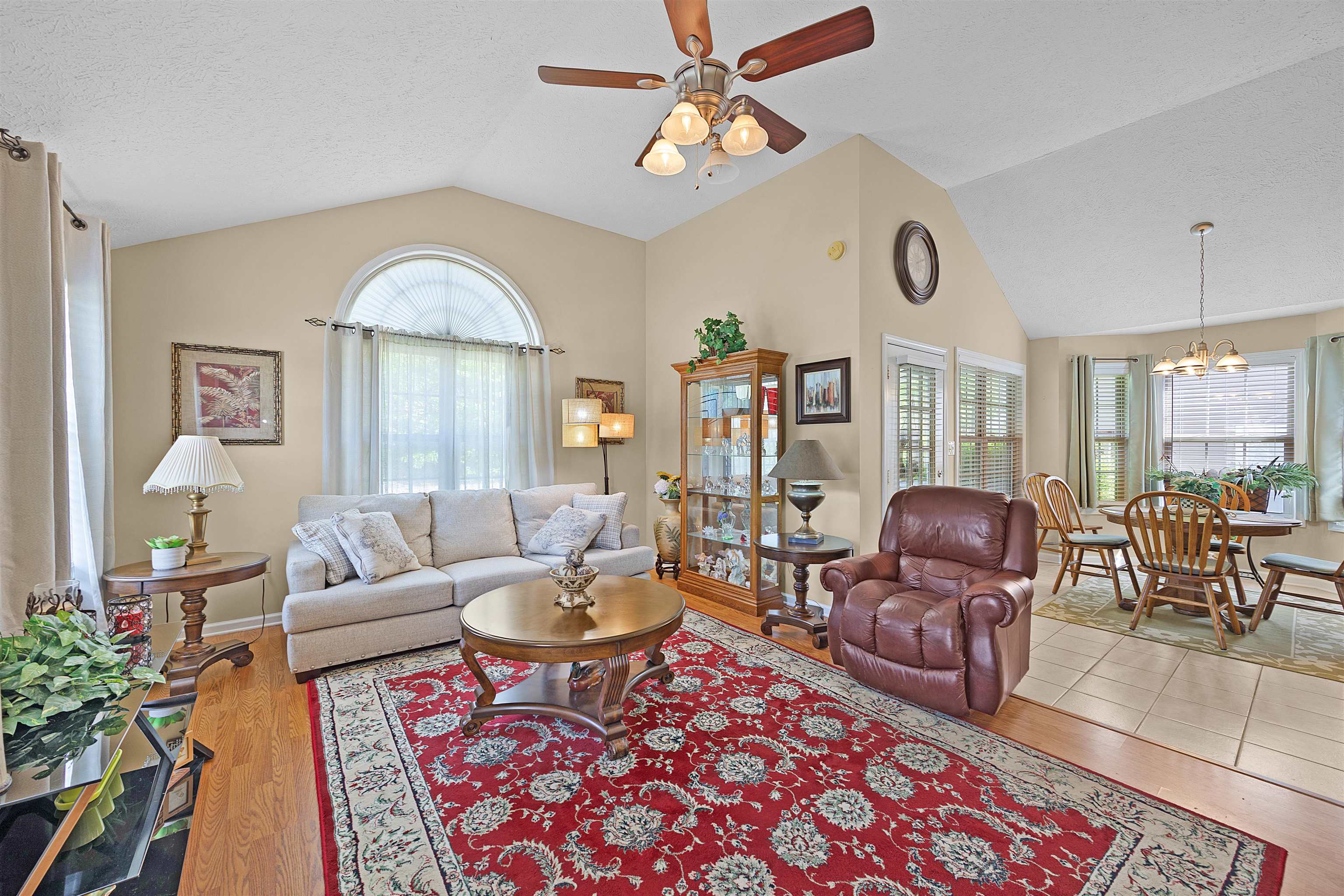 165 Ping Hl Cove Counce, TN 38326 - Photo 5 of 19 Living room featuring plenty of natural light, wood finished floors, and ceiling fan with notable chandelier