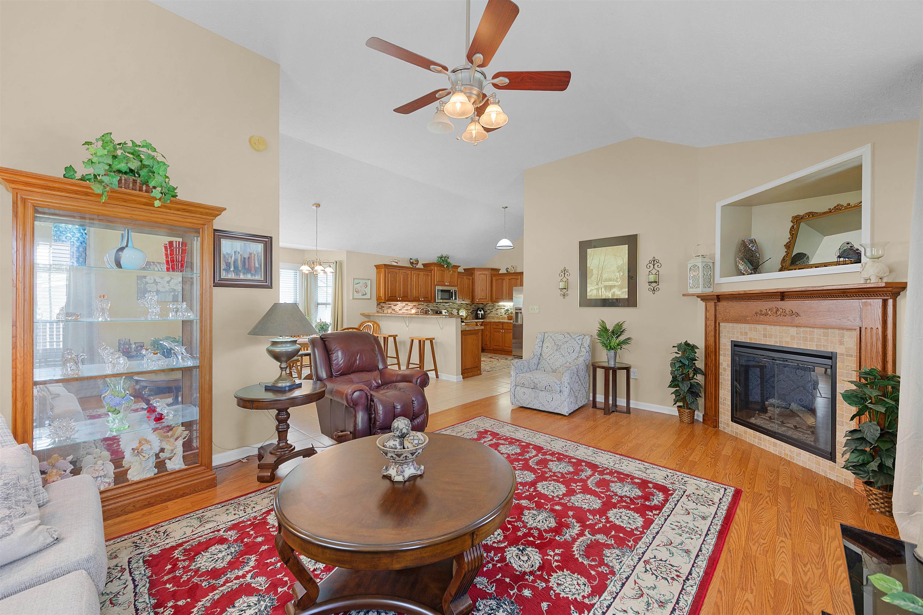 165 Ping Hl Cove Counce, TN 38326 - Photo 6 of 19 Living area featuring ceiling fan, a fireplace, vaulted ceiling, baseboards, and light wood-style floors