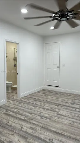 a view of a room with wooden floor