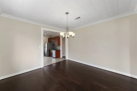 a view of a room with wooden floor chandelier and closet