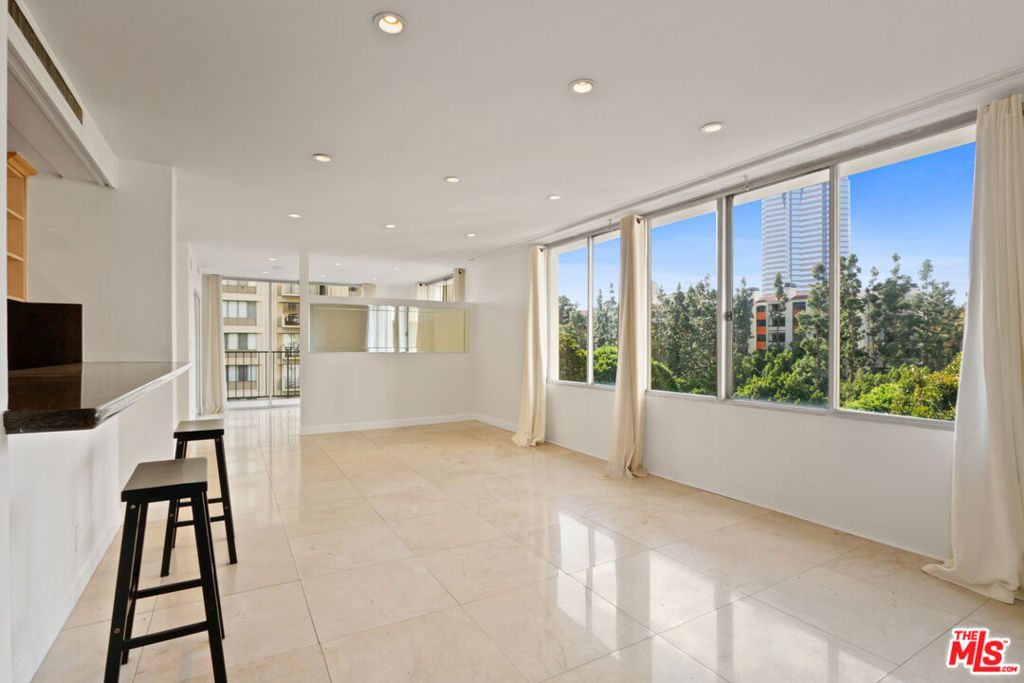 2160 Century Hill, Unit 605 Los Angeles, CA 90067 - Photo 3 of 18 a living room with furniture a flat screen tv and a large window
