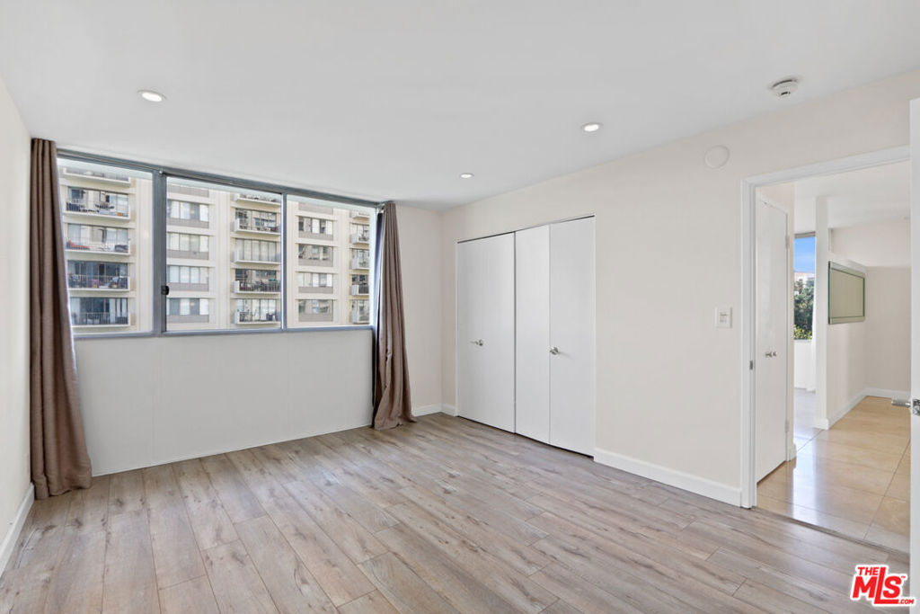 2160 Century Hill, Unit 605 Los Angeles, CA 90067 - Photo 7 of 18 a view of an empty room with wooden floor and a window