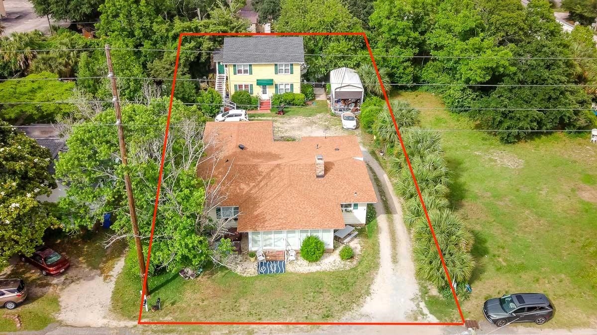 Aerial view of property and surrounding area with property parcel outlined