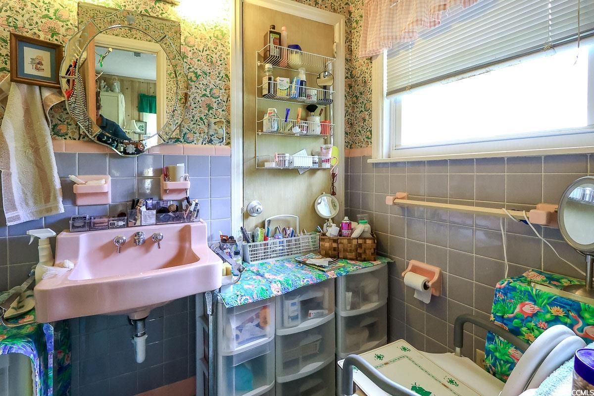 404 13th Avenue South Myrtle Beach, SC 29577 - Photo 12 of 38 Bathroom featuring wallpapered walls, a wainscoted wall, and tile walls