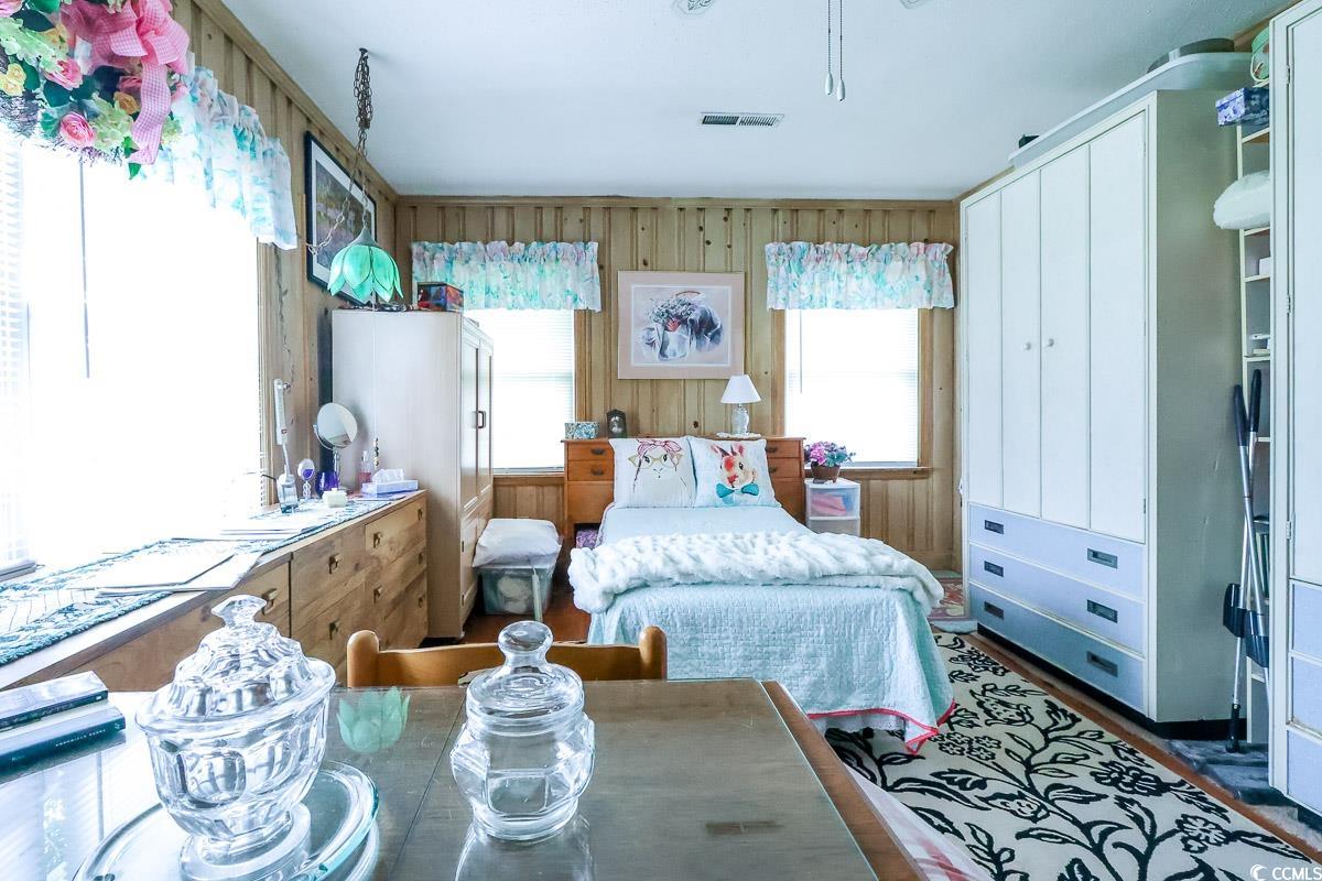 404 13th Avenue South Myrtle Beach, SC 29577 - Photo 15 of 38 Bedroom featuring wooden walls and wood finished floors