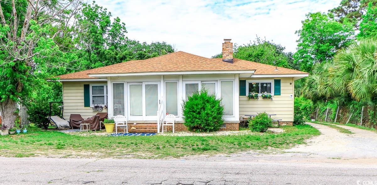404 13th Avenue South Myrtle Beach, SC 29577 - Photo 2 of 38 Back of house featuring entry steps, a shingled roof, and a chimney