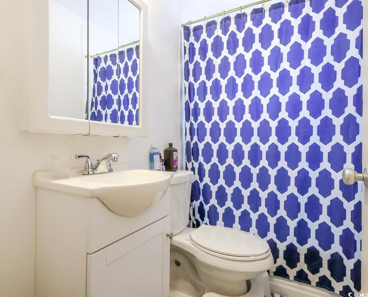 404 13th Avenue South Myrtle Beach, SC 29577 - Photo 34 of 38 Bathroom featuring vanity and a shower with curtain