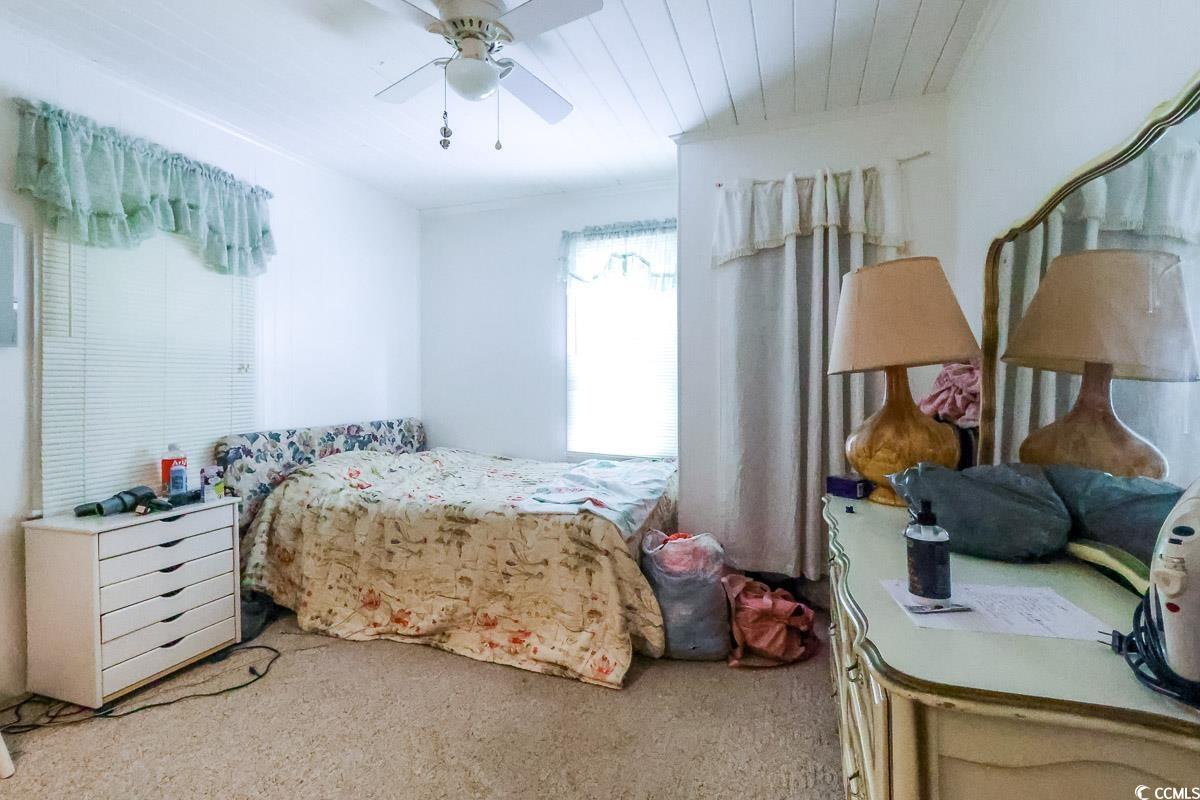 404 13th Avenue South Myrtle Beach, SC 29577 - Photo 35 of 38 Bedroom featuring light colored carpet and a ceiling fan