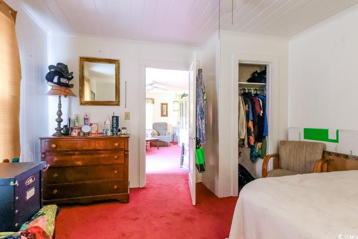 404 13th Avenue South Myrtle Beach, SC 29577 - Photo 36 of 38 Bedroom with carpet floors, crown molding, and a closet