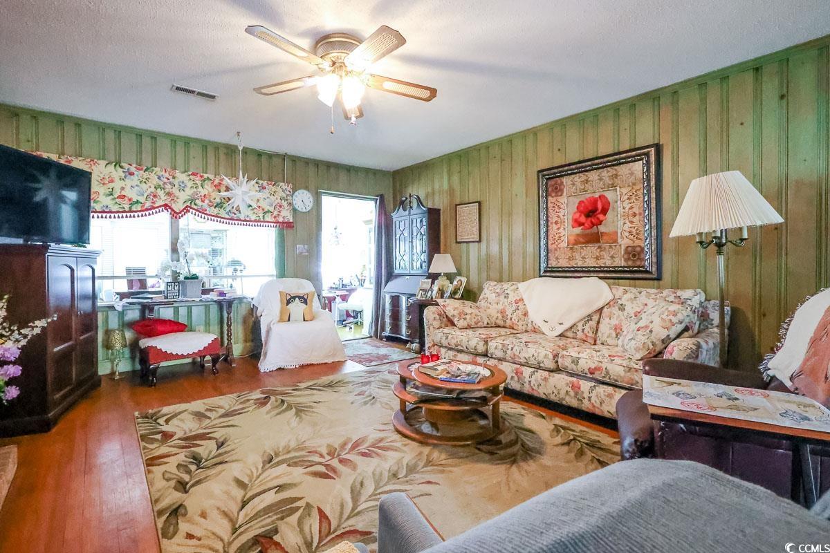 404 13th Avenue South Myrtle Beach, SC 29577 - Photo 4 of 38 Living area with wood finished floors, a textured ceiling, and ceiling fan