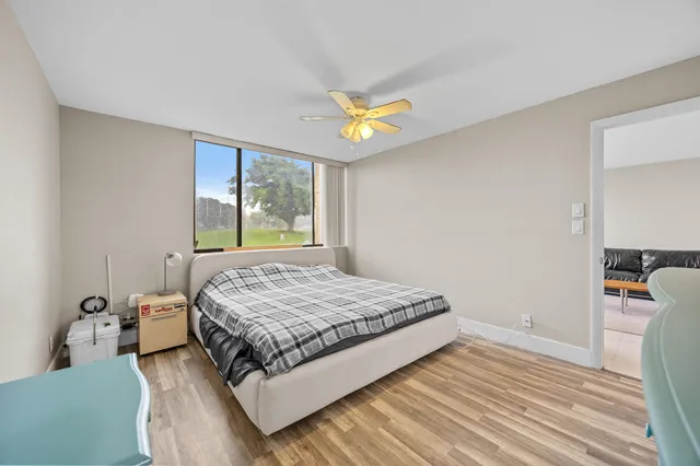 a bedroom with a bed dresser and a window