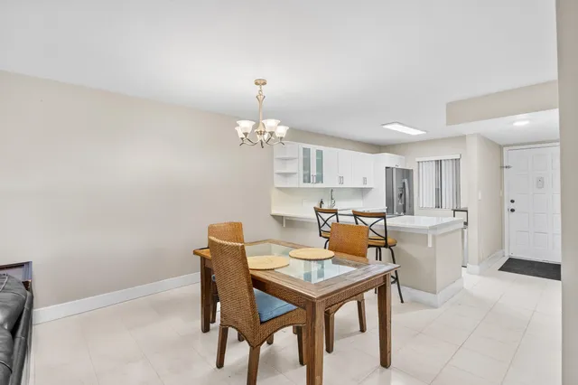 a view of a dining room with furniture and chandelier
