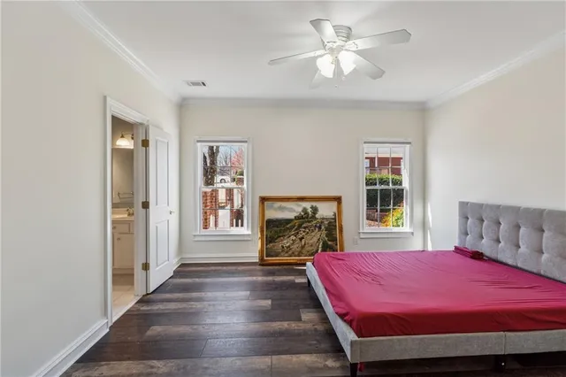 a bedroom with a bed dresser and a flat tv screen