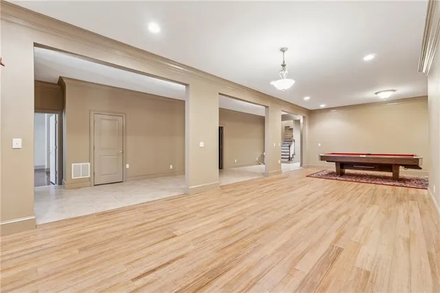 a view of empty room with wooden floor