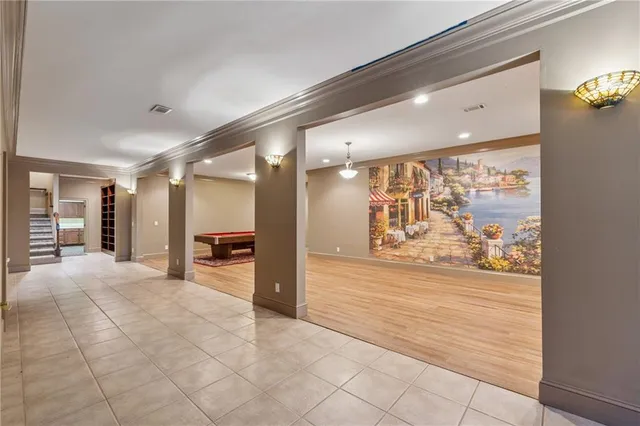 a view of a hallway with dining area and chandelier