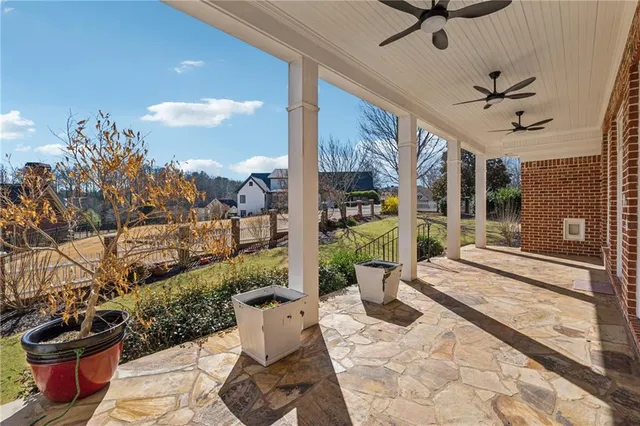a view of a patio with table and chairs potted plants