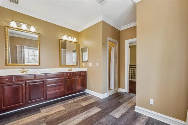 a spacious bathroom with a granite countertop sink and a mirror