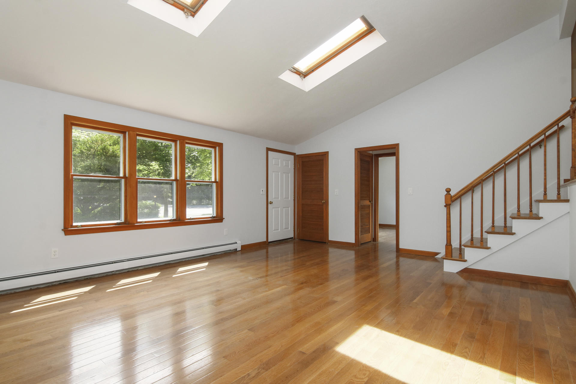 725 Old Stage Road Centerville, MA 02632 - Photo 5 of 53 a view of an empty room with wooden floor and a window