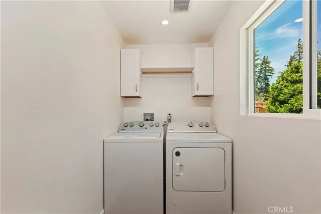 a bathroom with a granite countertop sink and white cabinets